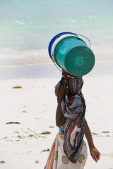person on white sandy beach on the east coast of Zanzibar, Tanzania