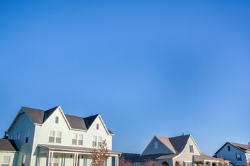 View of an upper part of a two-storey houses with different structures and colors