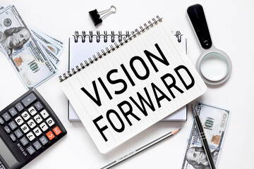 Vision forward. notebook on white workspace. near the notepad dollar bills and a calculator