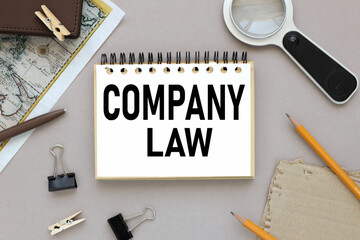 Corporate Law, COMPANY Law, text on notepad near magnifier and card with notepad