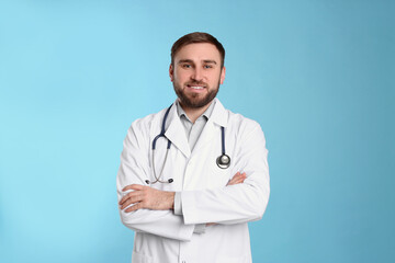 Fototapeta premium Pediatrician in uniform with stethoscope on light blue background