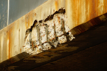 Corrosion damage on a concrete bridge.