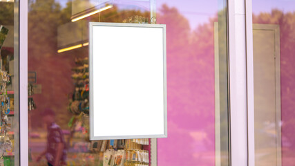 Advertising poster in the shop window. Against the background of pink walls