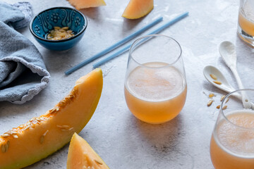 Fresh melon juice on the table, preparing melon  juice by raw ripe biological fruit, food background