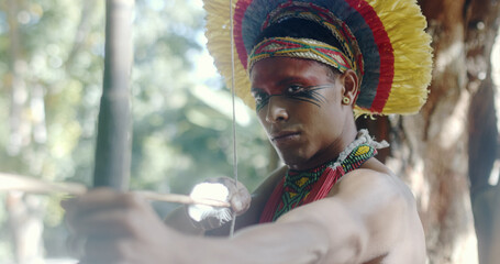 Indian from the Pataxó tribe using a bow and arrow. Indian's day. Brazilian Indian