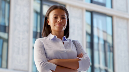 Medium shot of african businesswoman standing confident with arms crossed outdoor