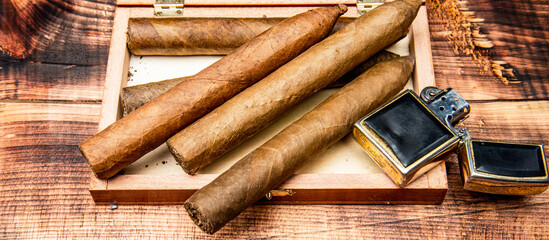 Cigars in box and vintage lighter. Cuban cigars wooden background. Cigar smoking. Cigar tobacco - obrazy, fototapety, plakaty