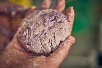Sweat colorful dough with berries in hand of Chief