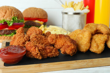 Concept of fast food on white wooden table