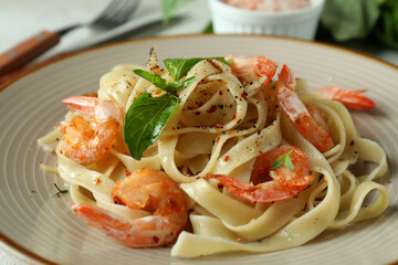 Concept of tasty eating with shrimp pasta on white textured table