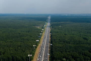 The road in the forest, view from the helicopter. View of the road 