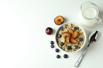 Concept of tasty eating with oatmeal on white background