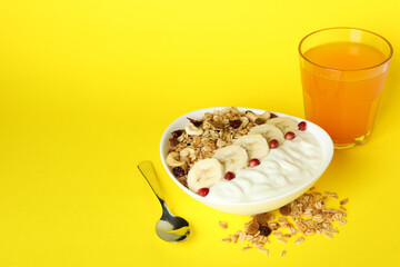 Concept of tasty eating with oatmeal on yellow background