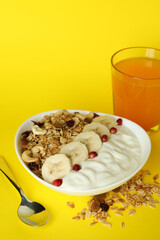 Concept of tasty eating with oatmeal on yellow background