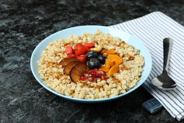 Concept of tasty eating with oatmeal on black smokey background