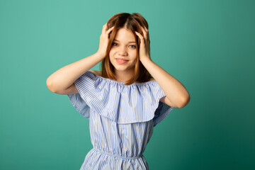 portrait of beautiful young cute woman on green background 