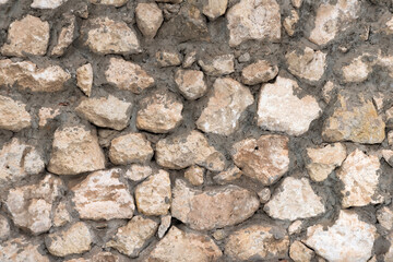 Obraz premium Neatly stacked rough cut stone wall seamless texture background