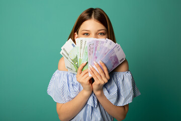 beautiful young woman with euro money in hands  - obrazy, fototapety, plakaty