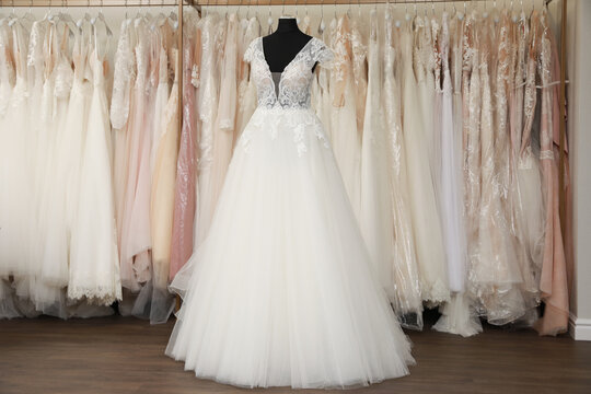 Beautiful wedding dress on mannequin in boutique