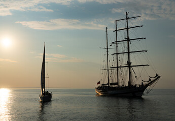 Sailing boat achored on Tallinn bay. 3 mast sailing yacht enjoying the sunset on calm Baltic sea. Beautiful weather and nice sky