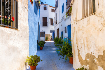 Narrow streets of Chelva, picturesque and brightly painted houses, on a sunny day.