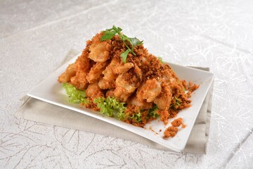 Deep fried crispy golden egg plant with chicken floss appetiser platter in white background appetiser halal menu