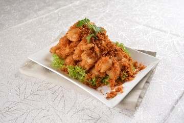 Deep fried crispy golden egg plant with chicken floss appetiser platter in white background appetiser halal menu