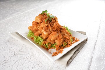 Deep fried crispy golden egg plant with chicken floss appetiser platter in white background appetiser halal menu