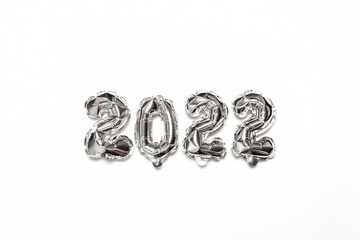 Helium balloons 2022, silver foil numbers on grey background. Party decoration, anniversary sign for holidays, celebration, carnival