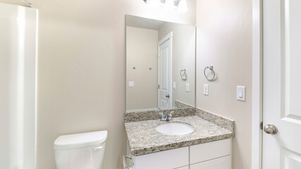 Naklejka na ściany i meble Pano Small white bathroom interior with ambient lightnings and closed white door
