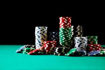 Stack of Casino gambling chips on green table