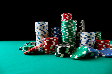 Stack of Casino gambling chips on green table