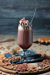 delicious and appetizing cup of cappuccino with whipped cream and caramel sauce and chocolate topping