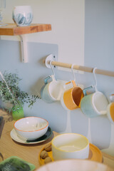Fototapeta na wymiar Details of a modern kitchen in a Scandinavian rustic style in light green shades.