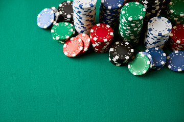 Stack of Casino gambling chips on green table