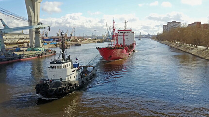 Tugboats assisting cargo ship sea in the morning.