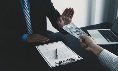 Government officials raise the hand refusing money to take the bribe from businessman, the concept...