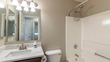 Pano Small bathroom interior with vanity sink and mirror cabinet