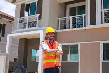 Asian male foreman constructor standing with his arms crossed with a determined face at the job site
