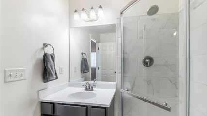 Pano Bathroom interior with vanity sink and corner shower stall