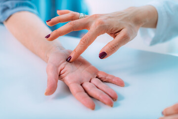 Examining Hand of Senior Patient with Carpal Tunnel Syndrome. Close-up Image of Senior Woman’s...