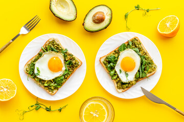 Open sandwich with avocado spinach cream and eggs. Top view