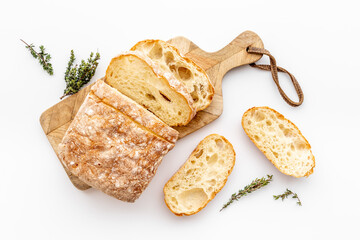 Sliced bread ciabatta with rosemary. Breakfast background - obrazy, fototapety, plakaty