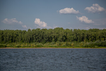 summer landscape, a cumulus cloud floats over the river