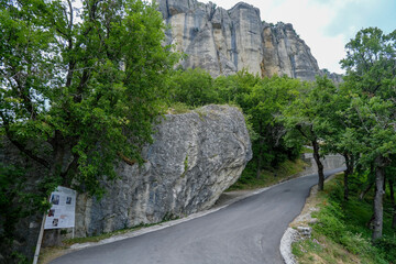 Fototapeta na wymiar mountain road in the mountains. View of the Pietra di Bismantova rock in Italy, Reggio Emilia from beneath. Mountains landscape 