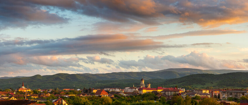 Majestic sunset with colorful clouds above the city of Caransebes