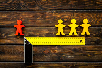 Keep social distance concept with two man figures and metal ruler