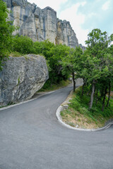 Fototapeta na wymiar mountain road in the mountains. View of the Pietra di Bismantova rock in Italy, Reggio Emilia from beneath