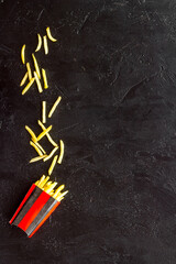 Potatoes french fries in paper box, top view