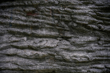 Gray texture background of the rock close-up with stripes. Natural background. copy space